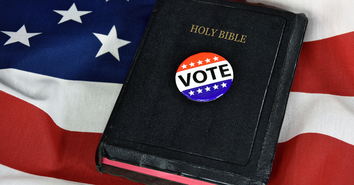 vote button on Bible on American flag